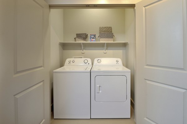 Laundry room with modern appliances at Broadstone Woodmill Creek Apartments, offering convenient amenities for residents