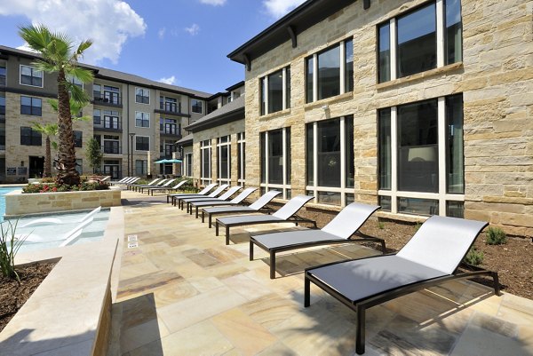 Resort-style swimming pool at Broadstone Woodmill Creek Apartments with lush landscaping