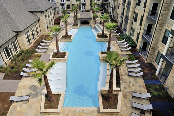 Luxury pool with sun loungers at Broadstone Woodmill Creek Apartments