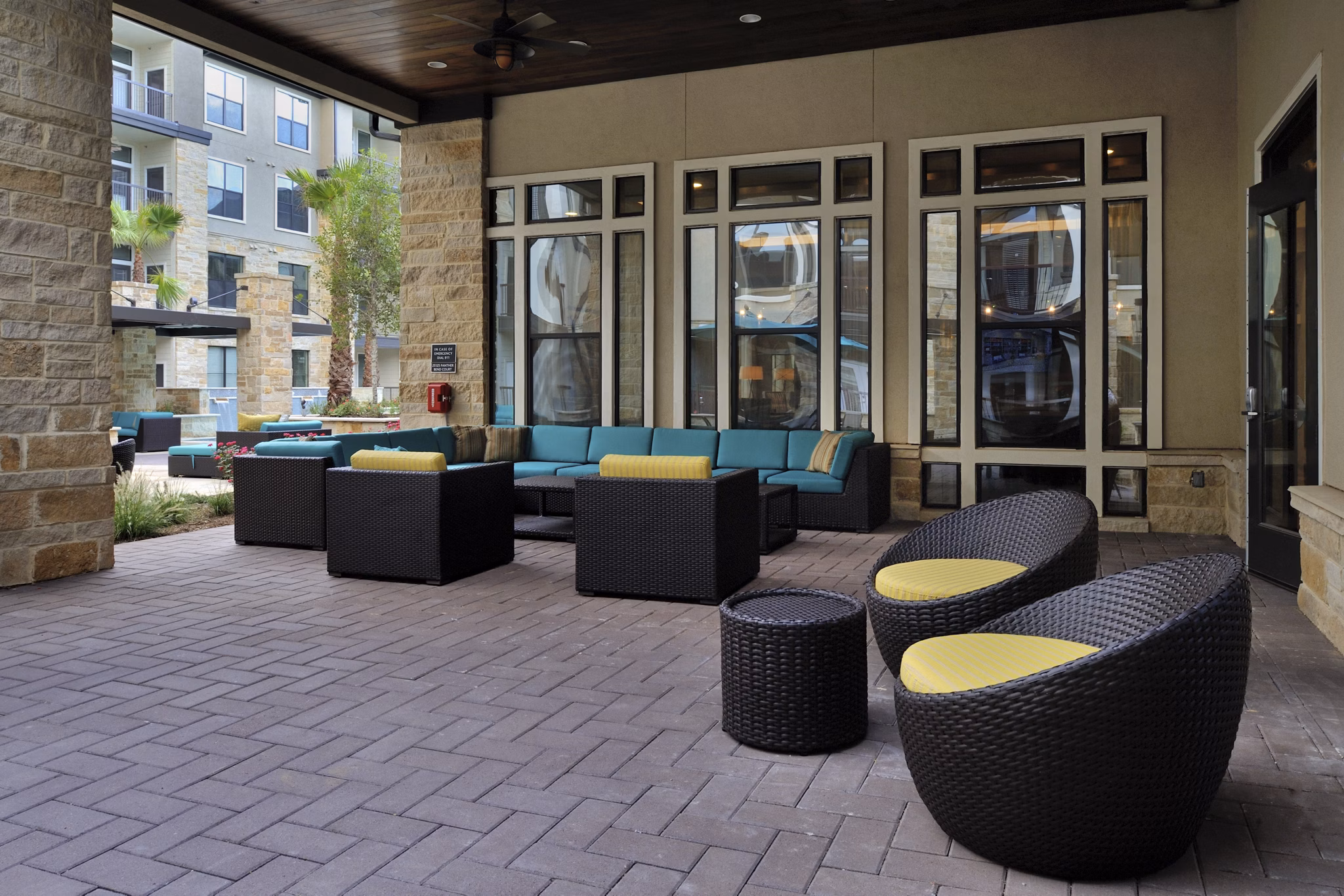 Charming patio with cozy seating and lush greenery at Broadstone Woodmill Creek Apartments