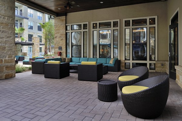 Charming patio with cozy seating and lush greenery at Broadstone Woodmill Creek Apartments
