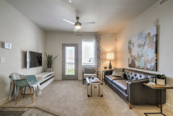 Spacious living room with plush seating and modern decor in Avanti at Farmington Station Apartments