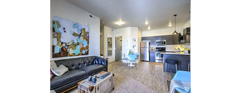 Cozy living room with modern furnishings at Avanti at Farmington Station Apartments
