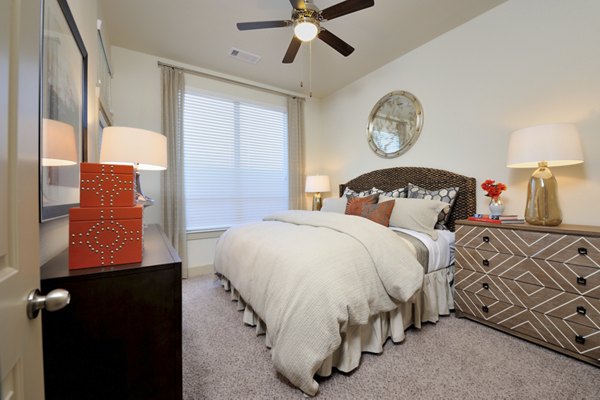 Modern bedroom featuring elegant decor and ample natural light at Broadstone Energy Park Apartments, luxury living in a prime location