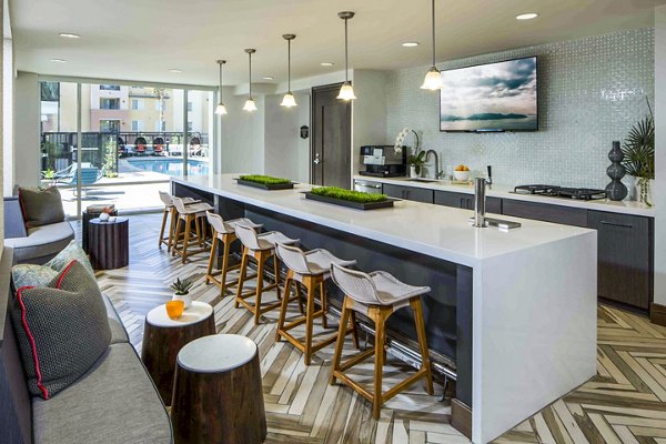 Clubhouse bar and modern kitchen at Jefferson Platinum Triangle Apartments, luxury community in Anaheim featuring upscale design and amenities
