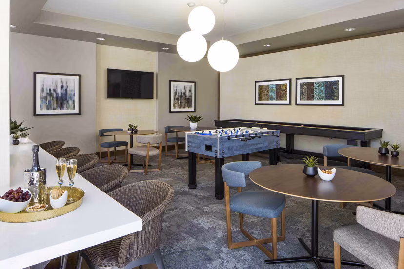 Jefferson Platinum Triangle Apartments: Modern game room with pool table and lounge seating for luxury living