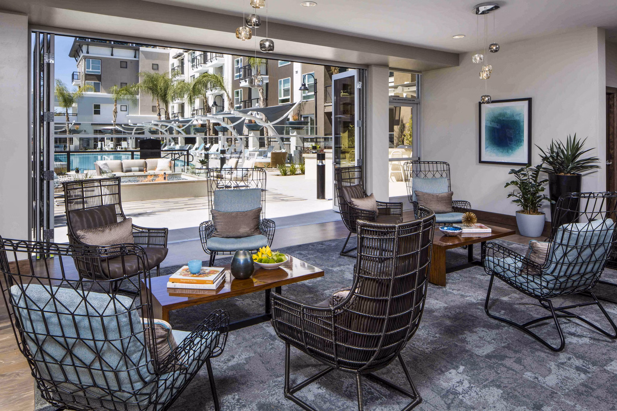 Clubhouse pool patio with lounge seating at Jefferson Platinum Triangle Apartments in Anaheim