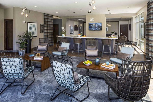 Clubhouse pool patio with lounge chairs at Jefferson Platinum Triangle Apartments, offering a relaxing outdoor experience in a luxury setting