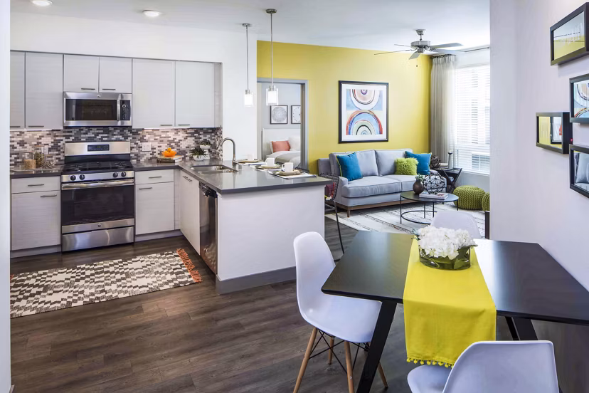Modern kitchen/dining room with stainless steel appliances in Jefferson Platinum Triangle Apartments