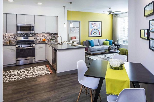 Modern kitchen/dining room with stainless steel appliances in Jefferson Platinum Triangle Apartments