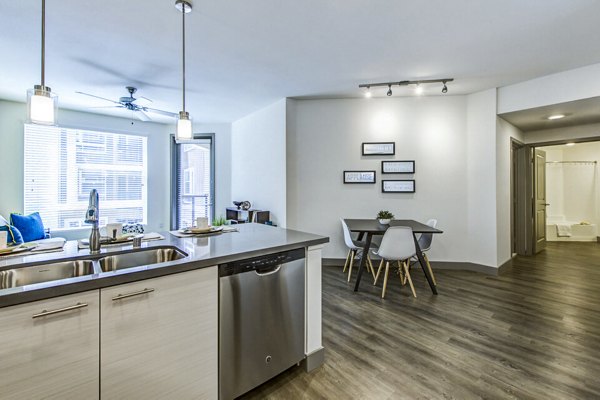 Modern kitchen with stainless steel appliances at Jefferson Platinum Triangle Apartments