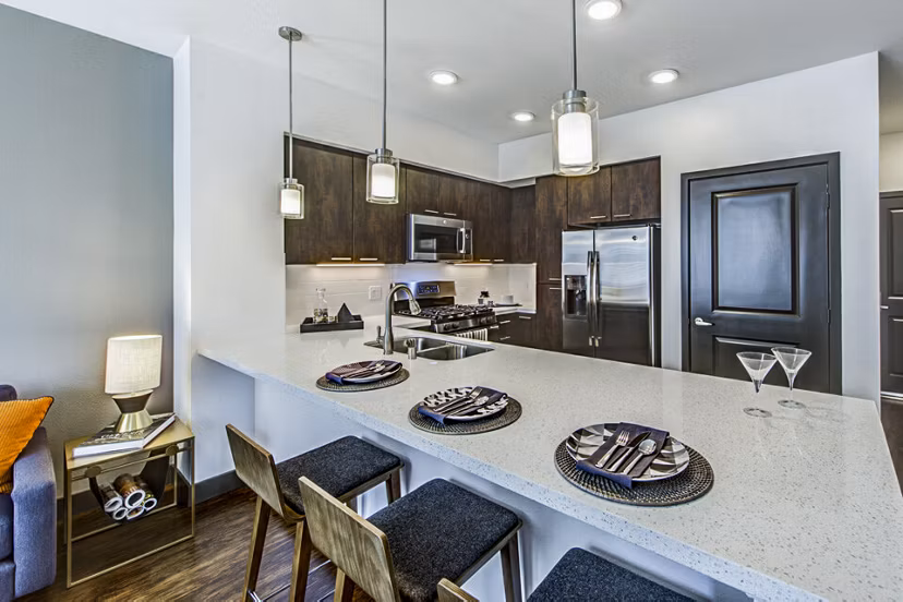 Modern kitchen with dining bar at Jefferson Platinum Triangle Apartments