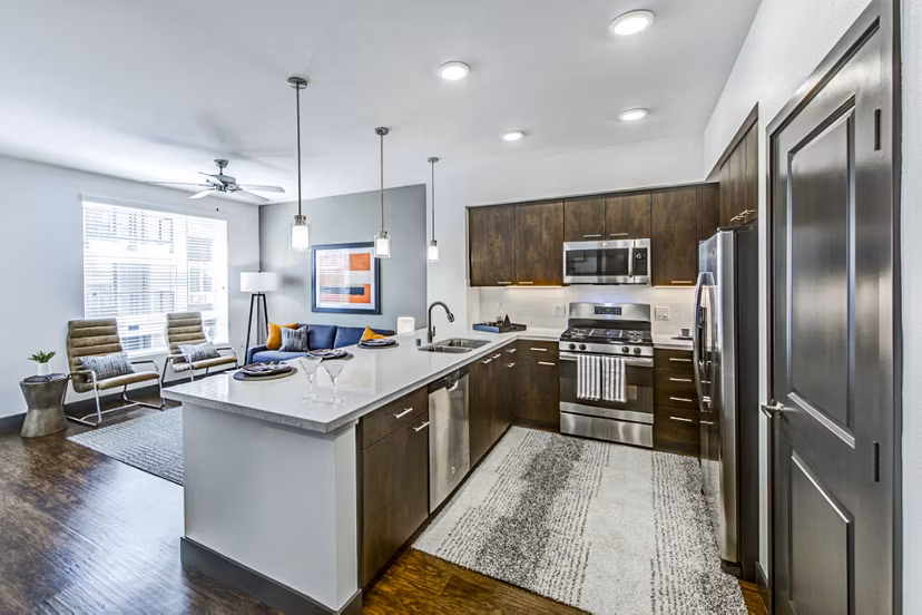 Modern kitchen with stainless steel appliances in Jefferson Platinum Triangle Apartments, Orange County