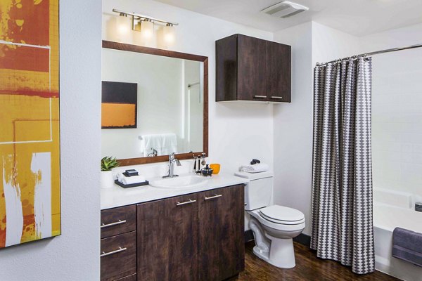 Modern bathroom with dual sinks and elegant fixtures at Jefferson Platinum Triangle Apartments in a luxury setting