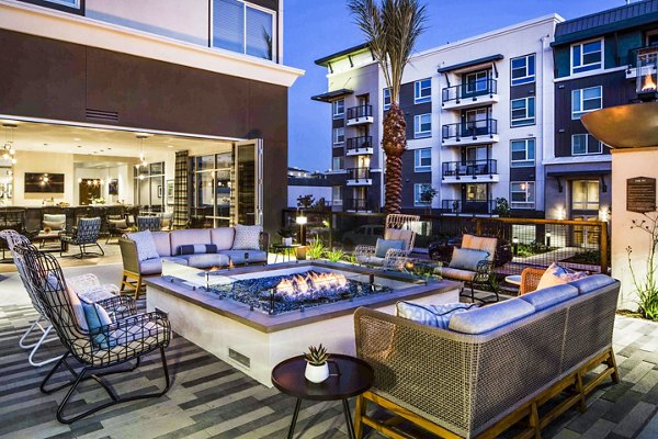 Cozy fire pit area at Jefferson Platinum Triangle Apartments, ideal for relaxation and socializing in a luxurious setting