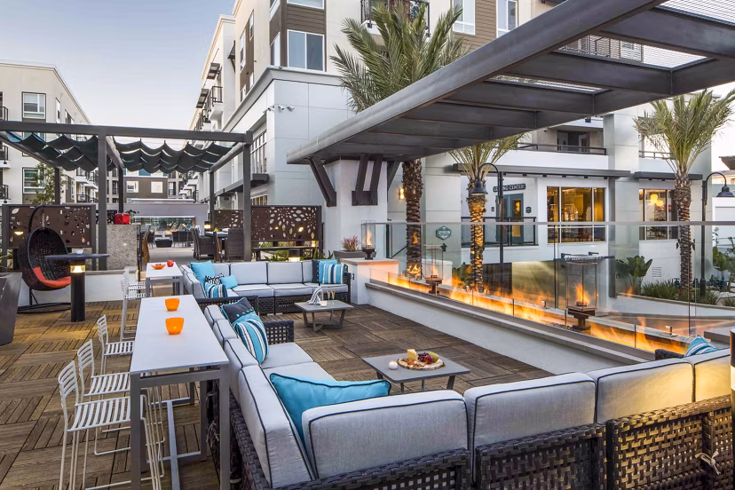 Outdoor fire pit lounge area at Jefferson Platinum Triangle Apartments offering cozy seating and ambiance