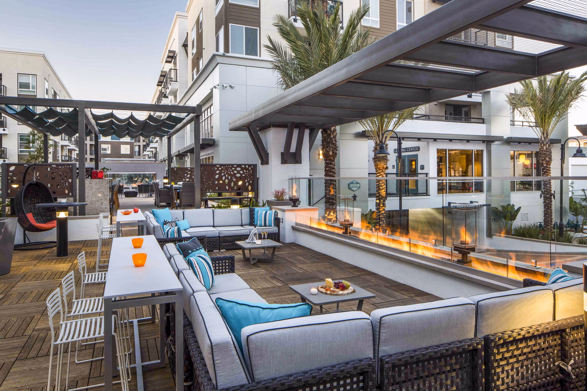 Outdoor fire pit lounge area at Jefferson Platinum Triangle Apartments offering cozy seating and ambiance