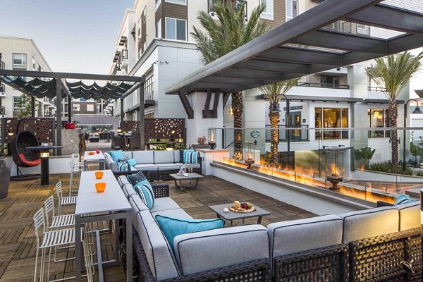 Outdoor fire pit lounge area at Jefferson Platinum Triangle Apartments offering cozy seating and ambiance