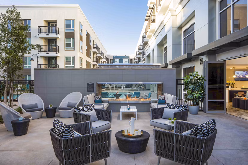 Cozy outdoor fire pit area at Jefferson Platinum Triangle Apartments featuring comfortable seating and ambient lighting