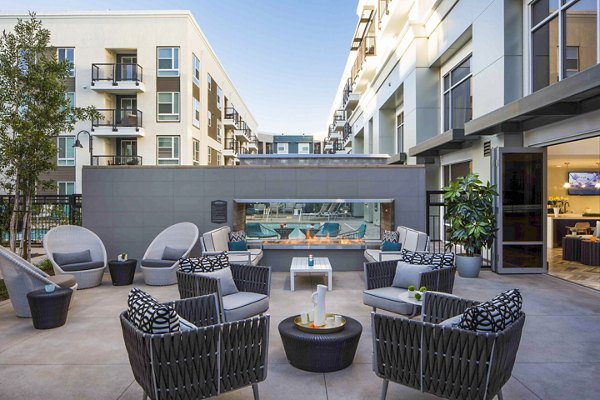 Cozy outdoor fire pit area at Jefferson Platinum Triangle Apartments featuring comfortable seating and ambient lighting