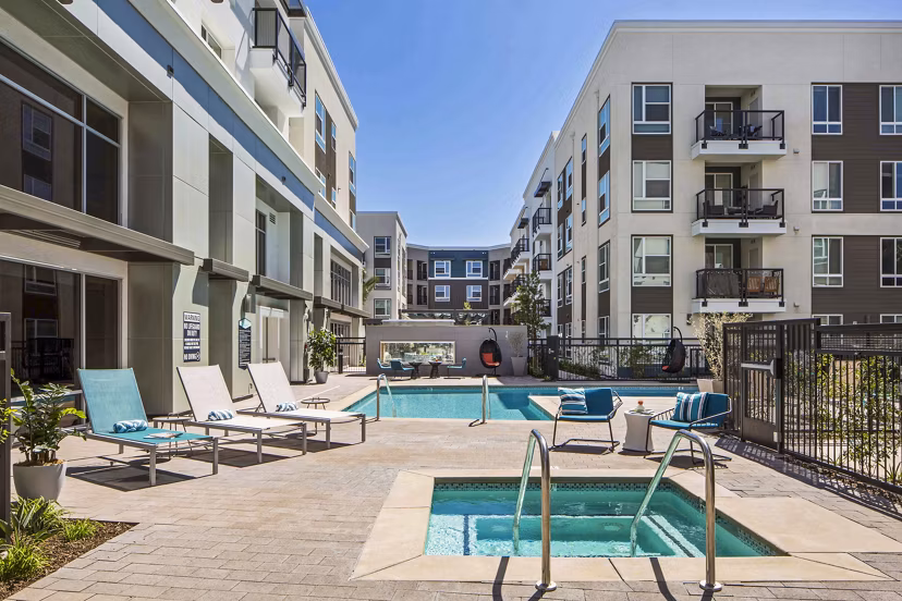 Relaxing pool and jacuzzi area at Jefferson Platinum Triangle Apartments