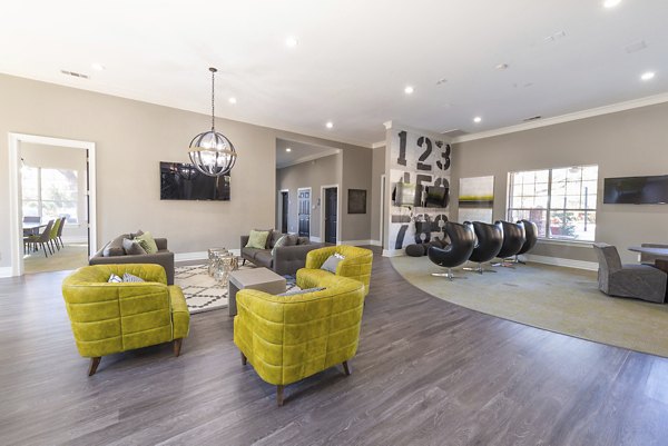 Clubhouse featuring modern furnishings and spacious lounge areas at Settler's Gate Apartments in Allen, Texas