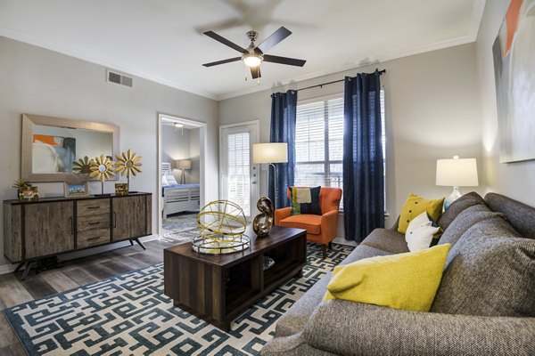 Spacious living room with modern furnishings in Settler's Gate Apartments, perfect for luxury living