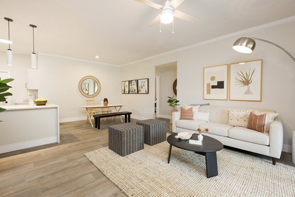 Comfortable living room with modern decor and ample natural light at Cantera Apartments