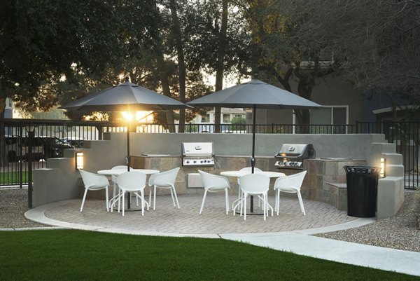 Grill area with outdoor seating at Cantera Apartments, perfect for hosting BBQs and social gatherings