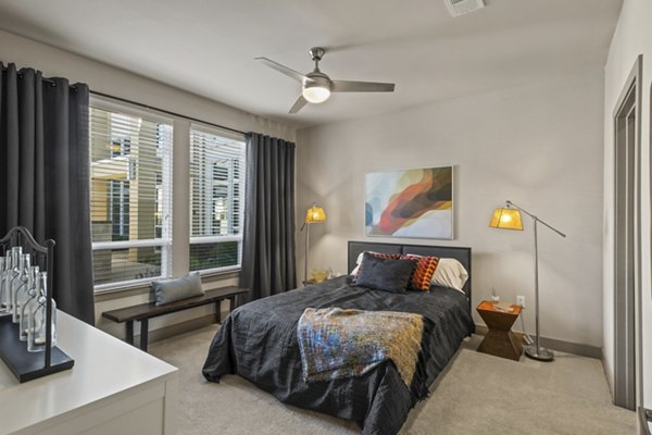 Spacious bedroom featuring modern furnishings at Avenue 900 Apartments