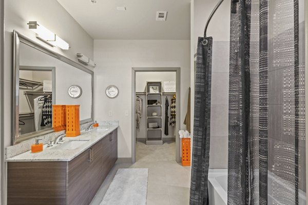 Bathroom showcasing modern fixtures and sleek design at Avenue 900 Apartments