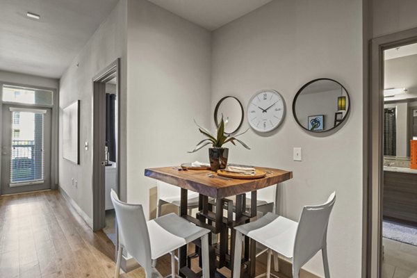 Dining area with modern furnishings at Avenue 900 Apartments Elegant setup with ample lighting and stylish decor for a luxurious dining experience