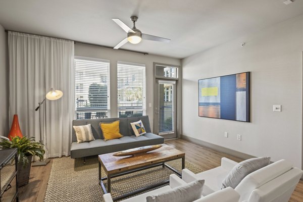 Spacious living room with modern furnishings at Avenue 900 Apartments