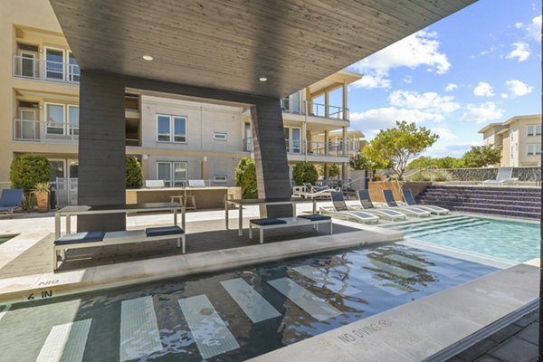 Resort-style pool with lounge chairs at Avenue 900 Apartments