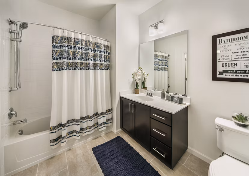 Elegant bathroom featuring marble countertops and chrome fixtures at 221 Bergen Apartments