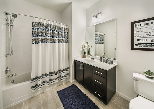 Elegant bathroom featuring marble countertops and chrome fixtures at 221 Bergen Apartments