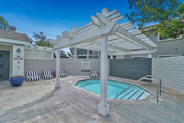 Upscale outdoor pool with sun loungers at The Galleria Apartments, a Greystar luxury community