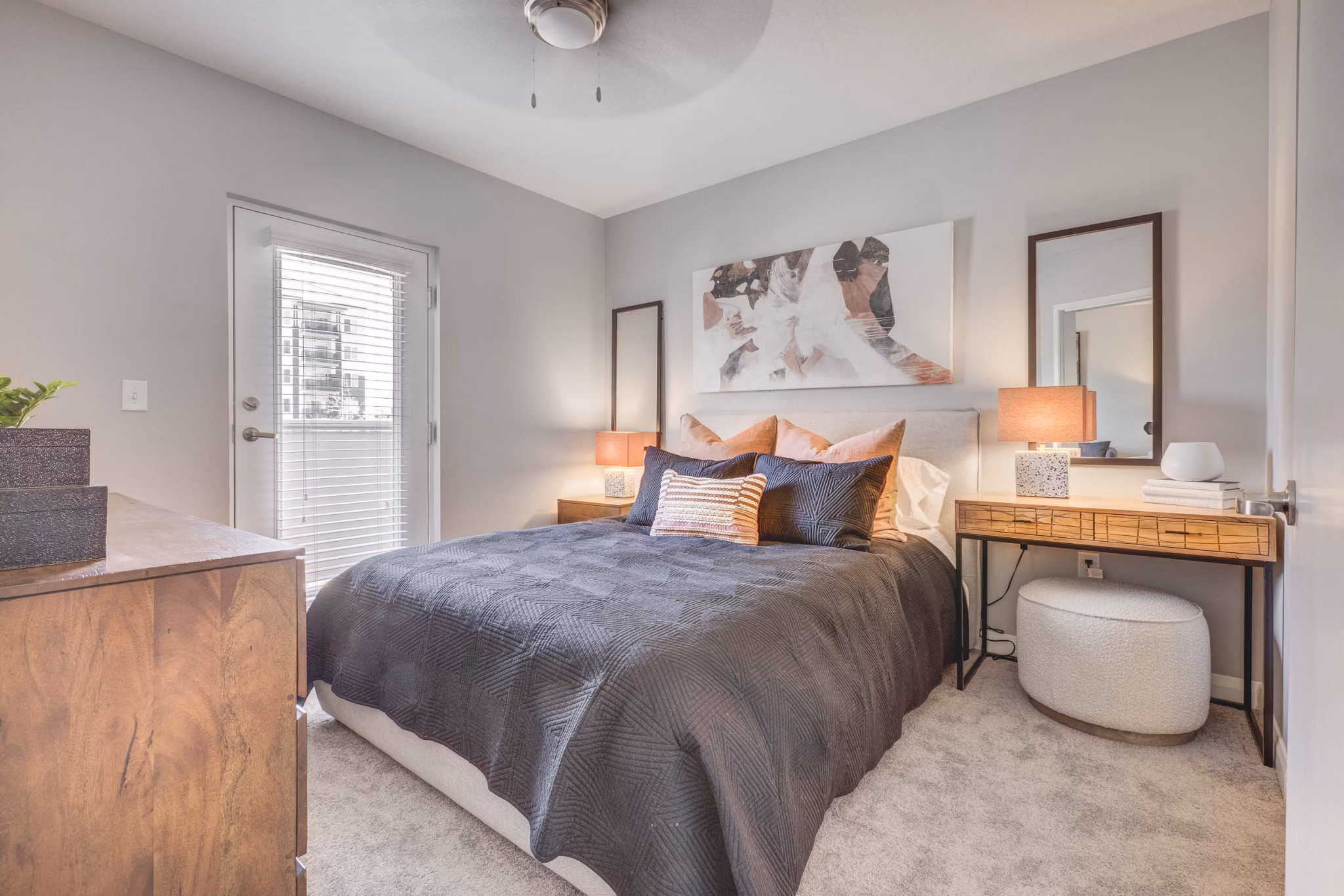 Cozy bedroom with modern decor at The Essex Apartments