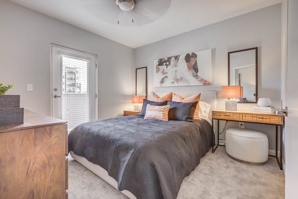 Cozy bedroom with modern decor at The Essex Apartments