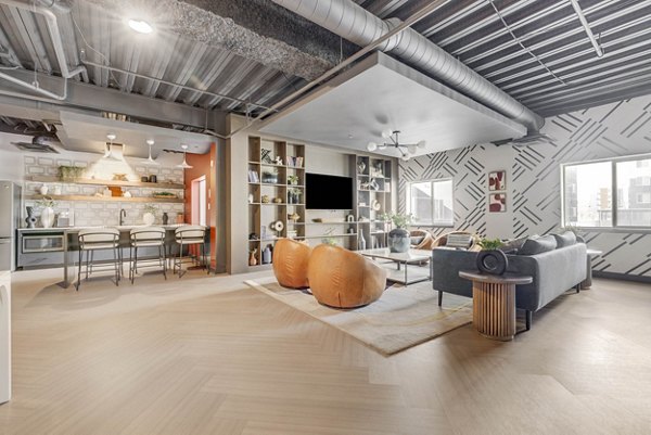 Clubhouse featuring modern design and cozy seating at The Essex Apartments