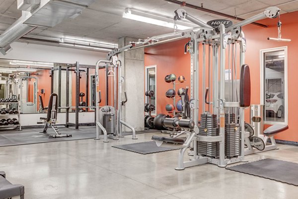 Spacious fitness center with modern equipment at The Essex Apartments