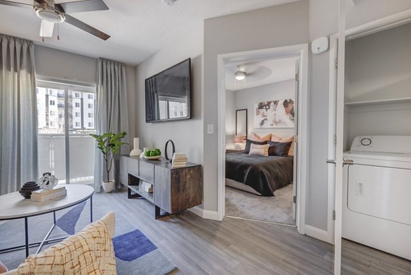 Open-concept kitchen with modern appliances at The Essex Apartments