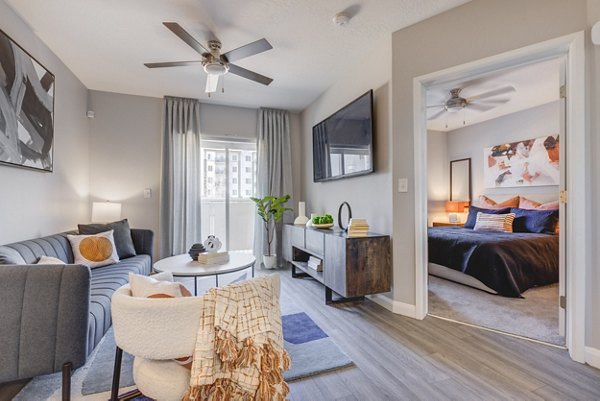 Spacious living room with modern design elements in The Essex Apartments