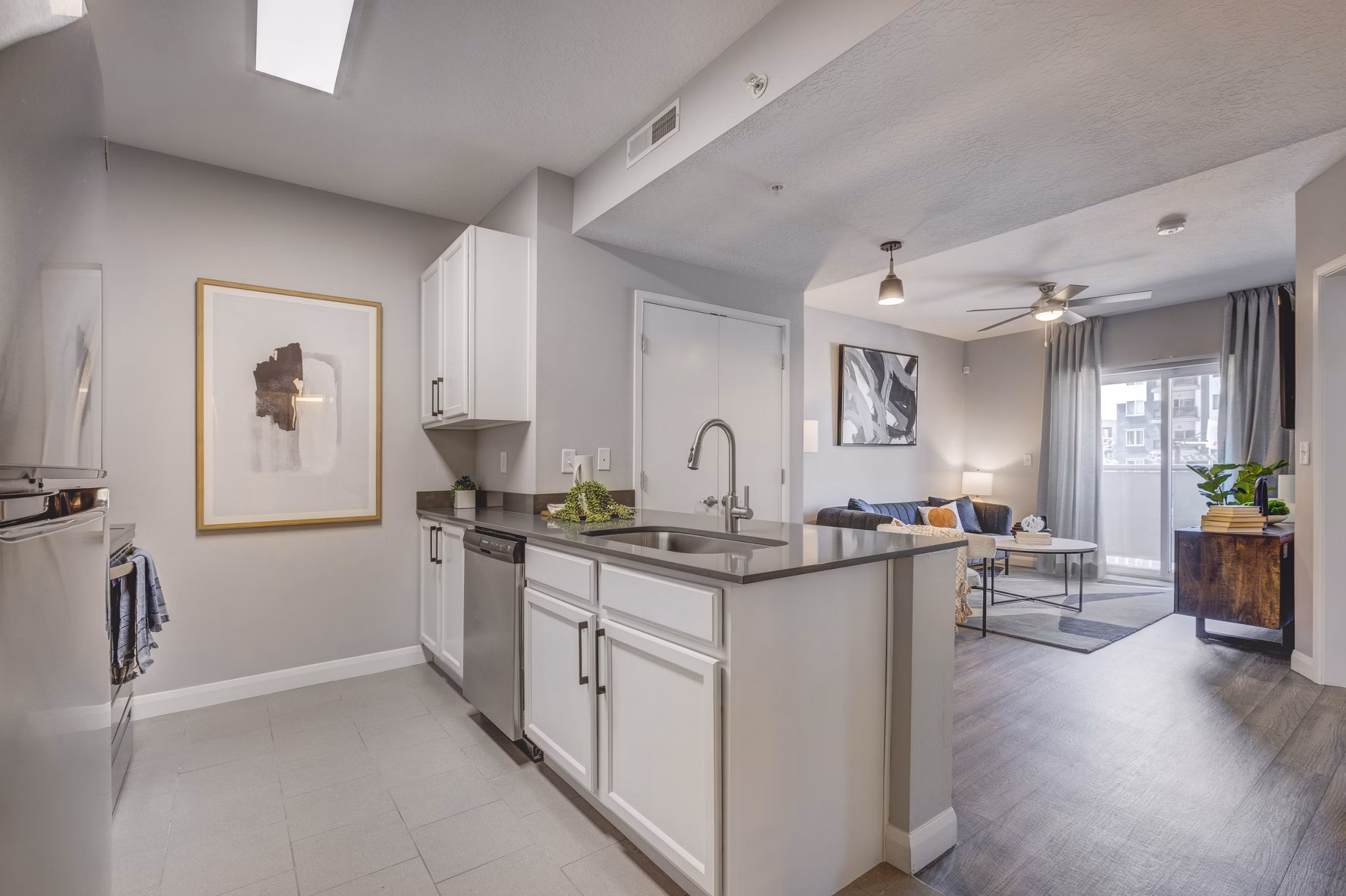 Modern kitchen with stainless steel appliances and granite countertops at The Essex Apartments