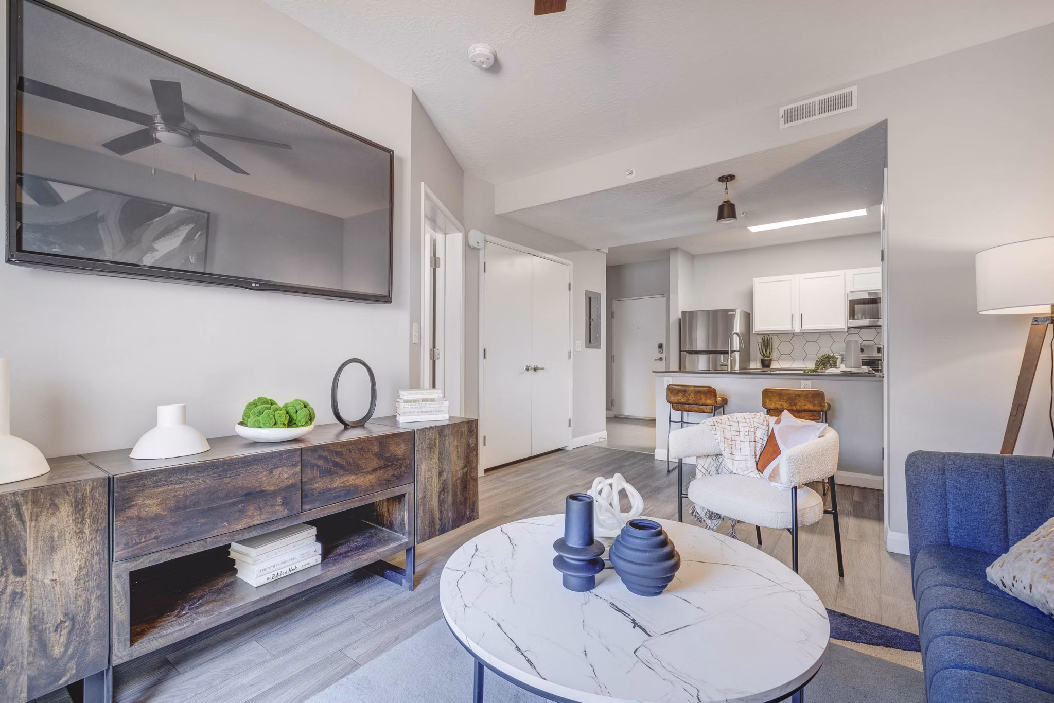 Living room featuring modern furniture and natural light at The Essex Apartments