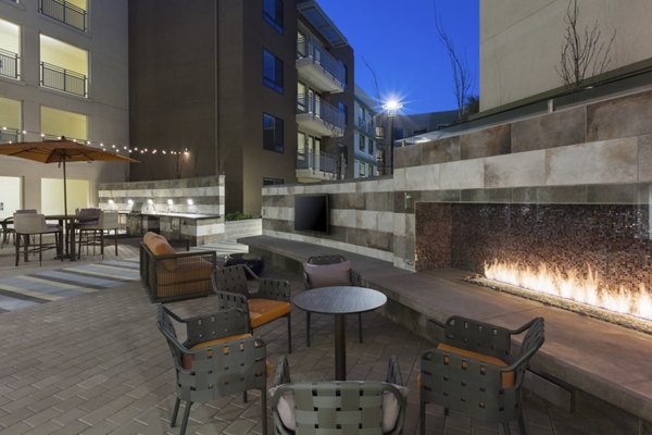 The Standard Apartments: Stylish patio with cozy seating and lush greenery in a luxury community featuring modern design