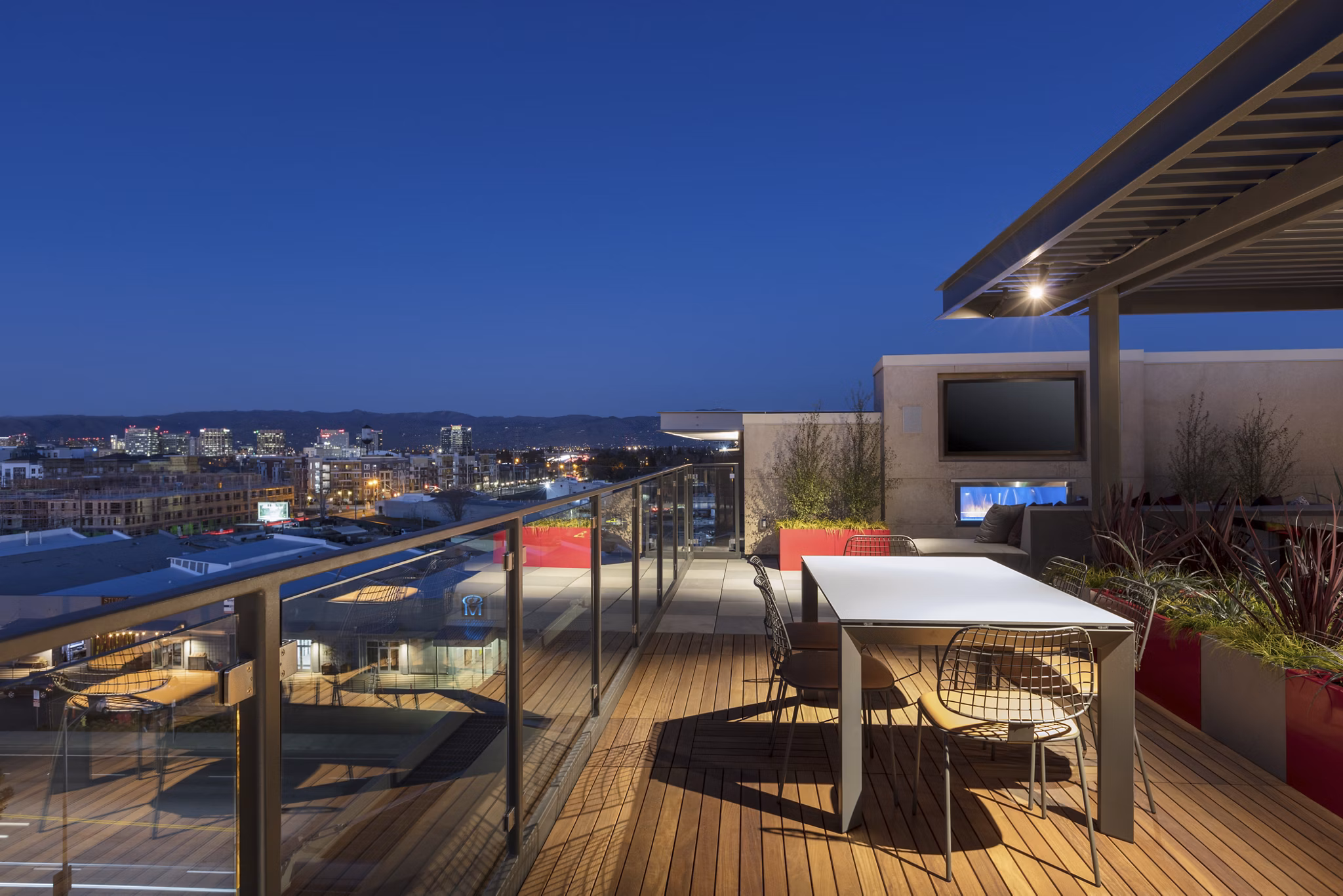 The Standard Apartments: Modern patio with comfortable seating and lush greenery, offering a luxurious outdoor living experience in the city