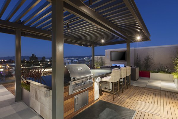 Grill area at The Standard: Outdoor barbecue space with seating for residents at Greystar luxury apartments