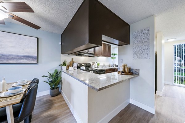 Dining room with modern decor at Harbor Park Apartments, featuring elegant lighting and a spacious table