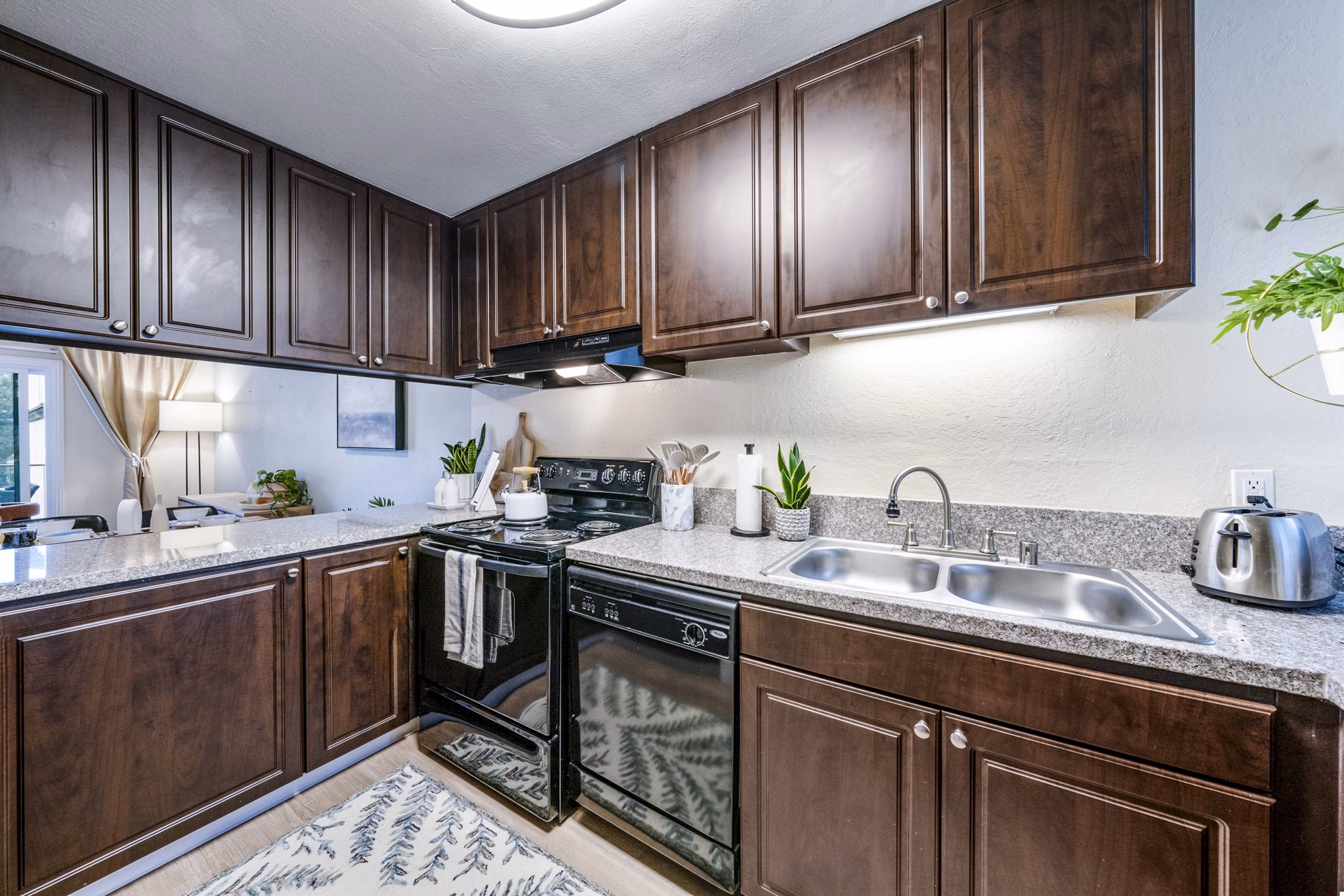 Modern kitchen with stainless steel appliances at Harbor Park Apartments in luxury Greystar community